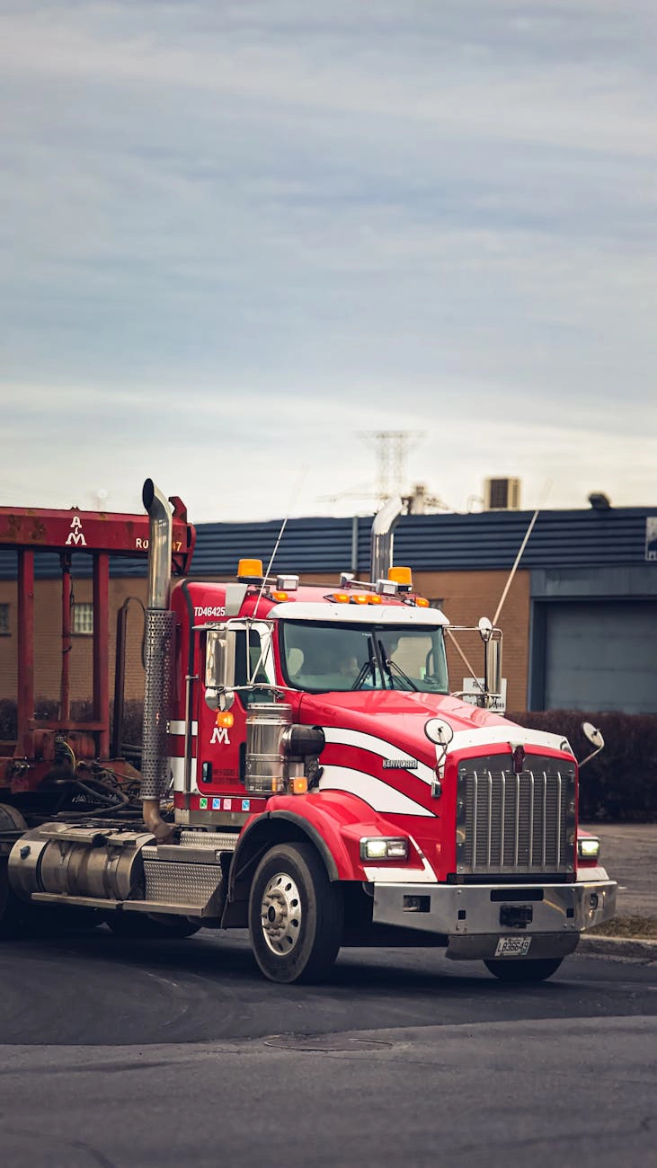 A red commercial truck on a street.