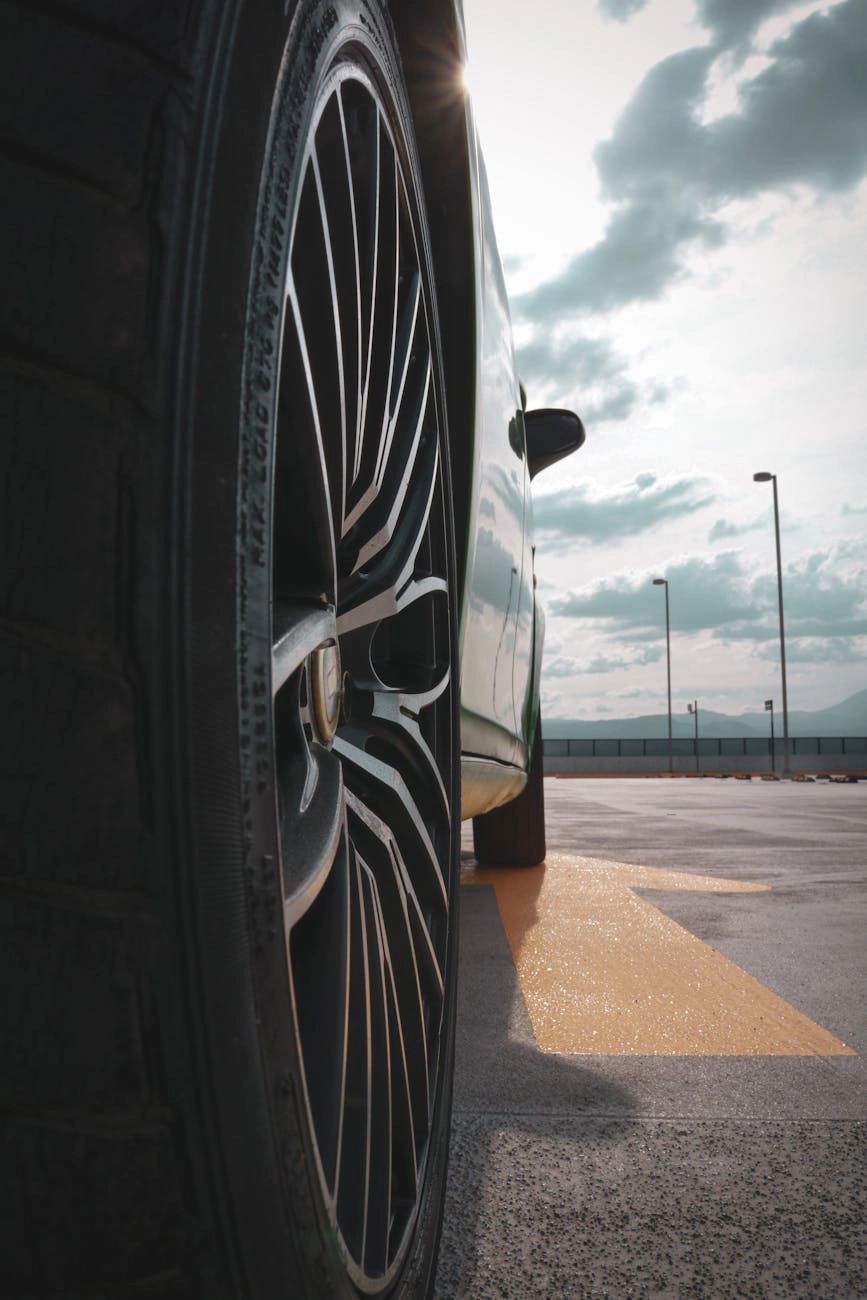 Close-up of a vehicle wheel on a parking deck.