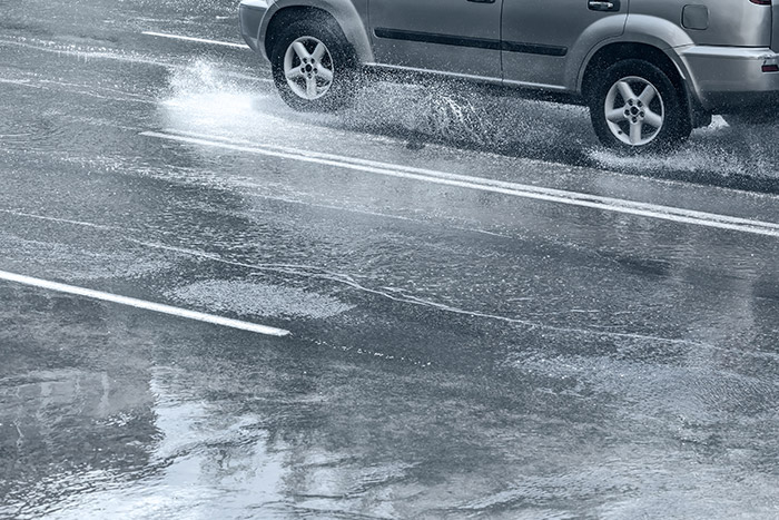 Car driving on a wet road